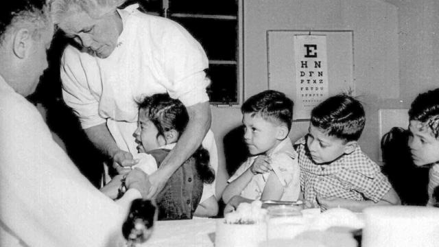 Children receive the polio vaccine - 1955 file photo 