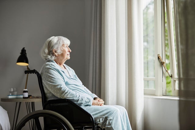 Contemplated senior female sitting on wheelchair
