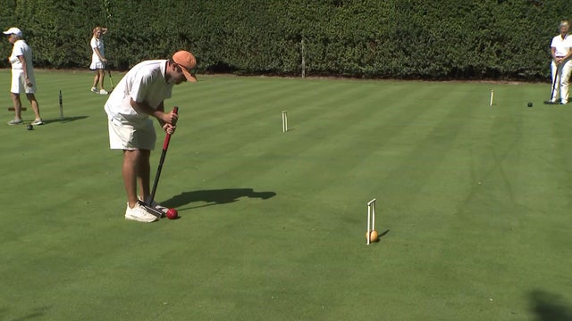 Matthew Essick plays golf croquet at Quogue Field Club. 