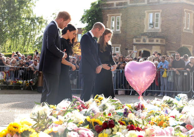 Prince William, Prince Harry and their wives view flowers at a memorial to Queen Elizabeth II outside Windsor Castle 