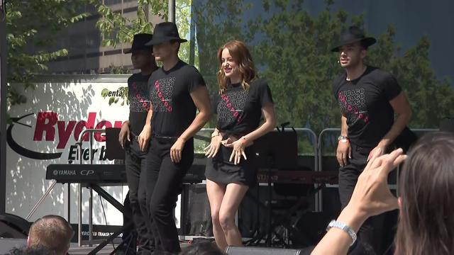 Cast members from Broadway's "Chicago" perform on stage in a park in Brooklyn. 