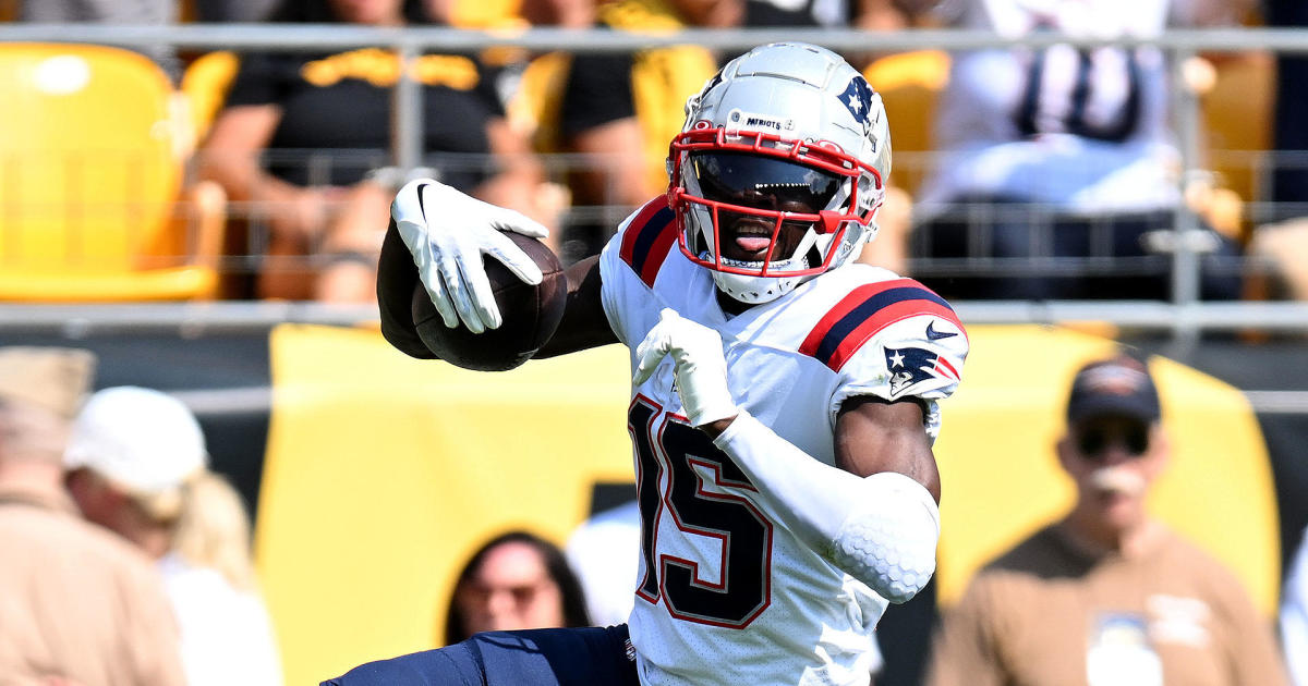 New England Patriots wide receiver Nelson Agholor (15) heads for the end  zone after a touchdown pass from New England Patriots quarterback Mac Jones  during the first half of an NFL football