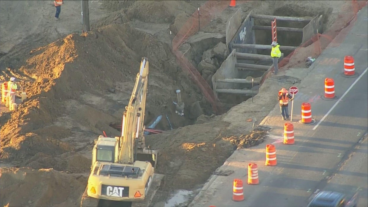 Excavator breaks water main after falling into hole at construction ...