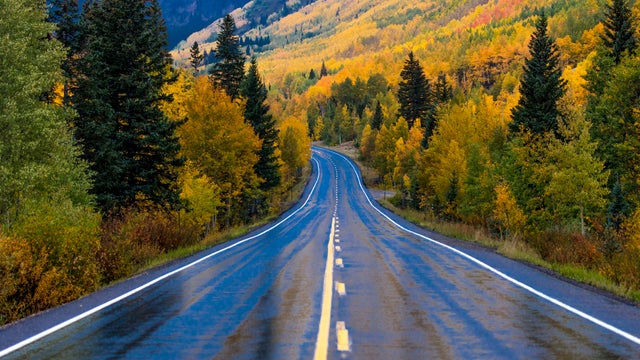 Wet autumn road goes from Ouray to Silverton Colorado, the Million Dollar Highway with color, Route 550 