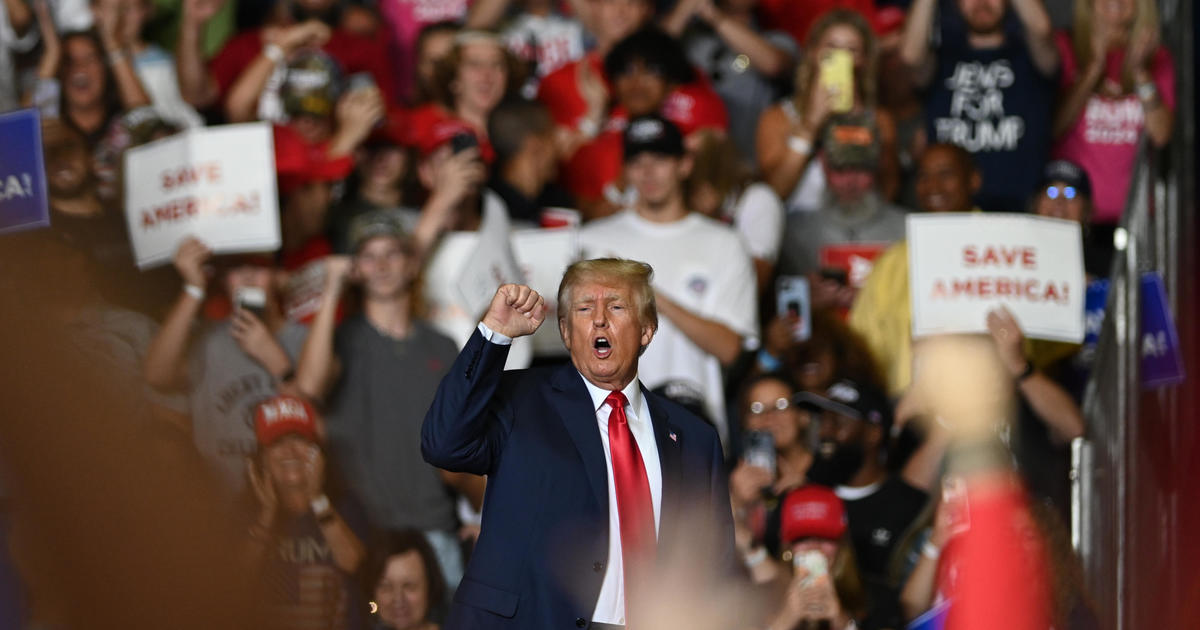 Trump signals affinity with QAnon followers in social media post, at rallies