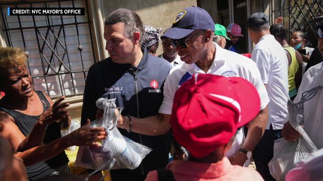Mayor Eric Adams hands out bags of supplies in the Dominican Republic. 