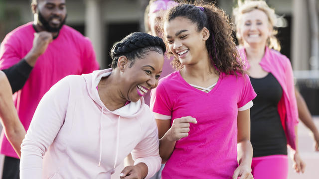 Woman, teenage girl, with group at breast cancer walk 