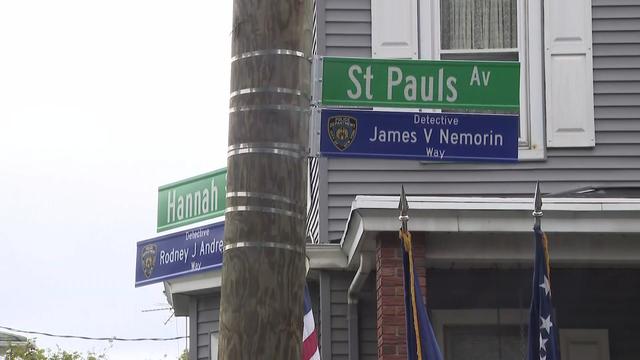 Street signs on a pole in Staten Island reading "Detective James V. Nemorin Way" and "Detective Rodney J Andrews Way." 