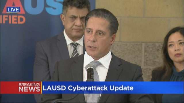 Digital tablet and book on desk in classroom 