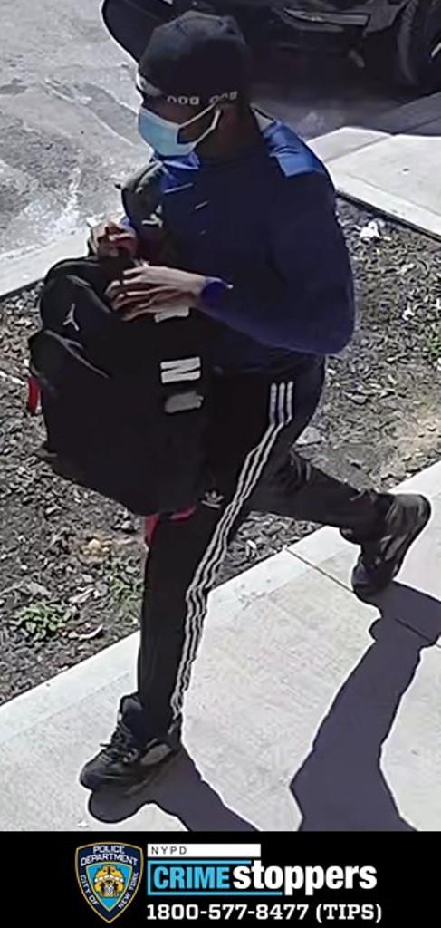 Surveillance photo of a man accused of robbing a Brooklyn convenience store at gunpoint.