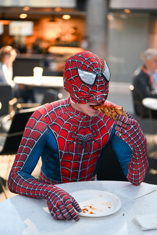 A Spider-Man cosplayer poses with pizza during New York Comic Con 2022 on October 06, 2022 in New York City. 