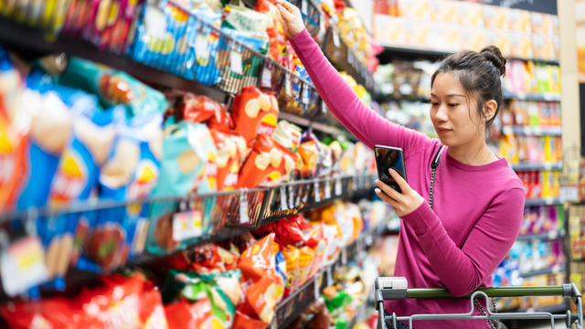 asian female shopping in supermarket 