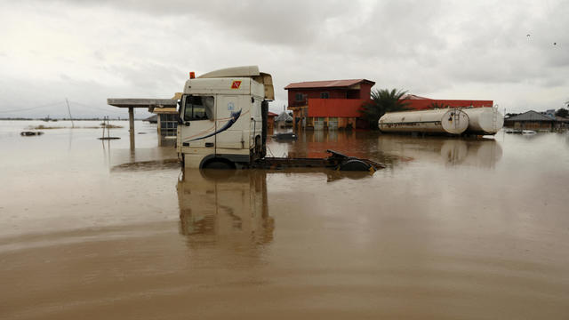 Vehicles are seen submerged in flood water at a petrol station in Lokoja 