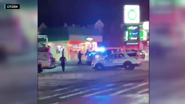Police cruisers sit parked in front of a BP gas station. 
