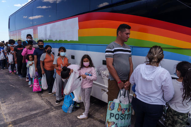 Migrants wait to board a bus in El Paso, Texas 