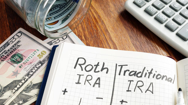 Roth IRA vs Traditional IRA written in the notepad. 