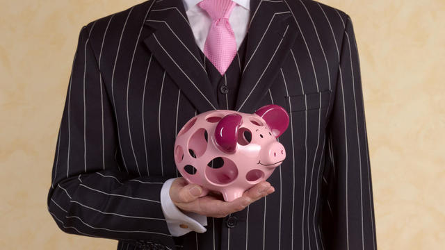 Banker/financial advisor with holey piggy bank 
