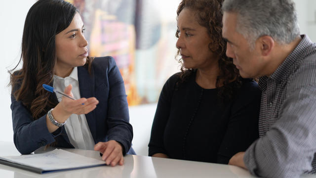 Ethnic Senior Couple With Financial Advisor 