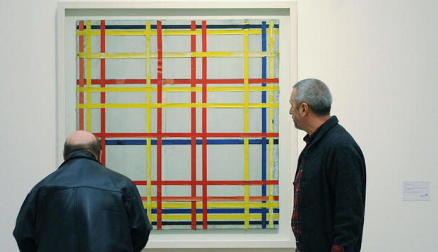 Two men inspect the painting "New York C 