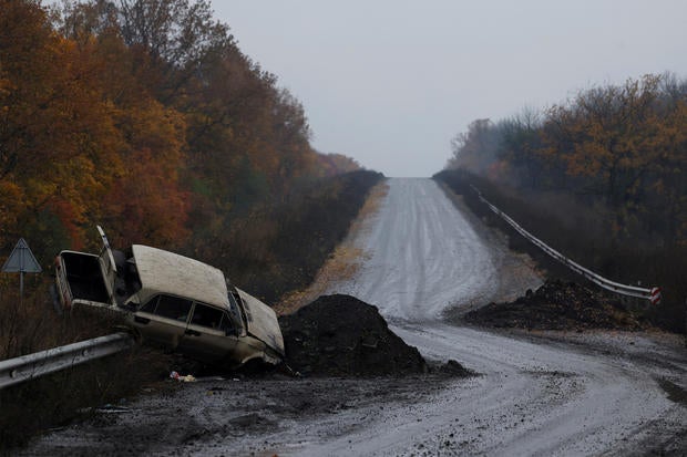 A destroyed car is seen on the main road, in Bakhmut 