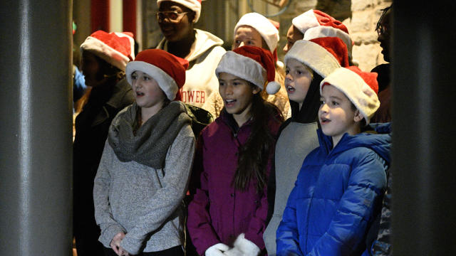 Carolers perform for a crowd of gathered families in anticipation of the arrival of Santa Claus, during a pre-Thanksgiving Day Circle of Trees lighting ceremony, in the Chestnut Hill neighborhood of Philadelphia, PA, on November 23, 2019. 