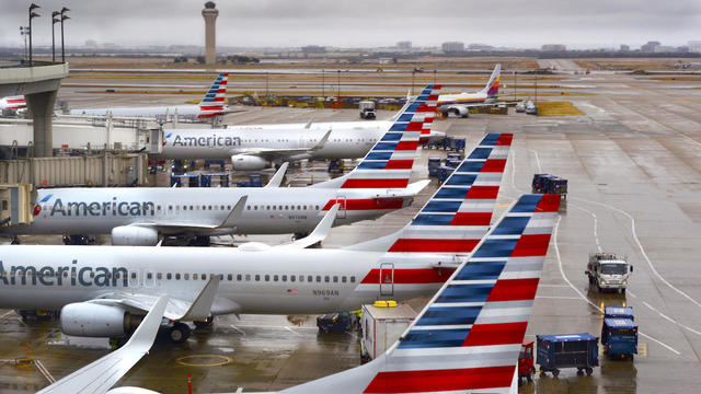 American Airlines passenger jets are seen parked at their gates on a rainy morning at Dallas Fort Worth International Airport on Dec. 8, 2018. 