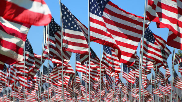 American flags blow in the wind on a bright sunny day in Malibu, California 