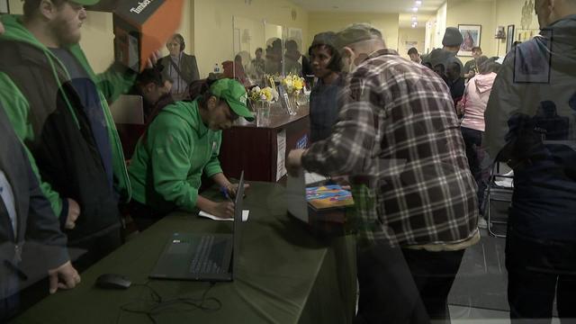 Masbia relief team members hand out steel-toe work boots to asylum seekers. 