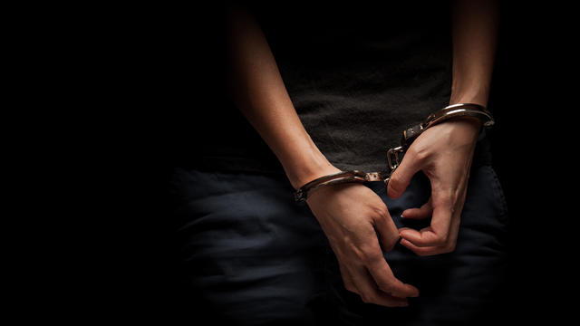 Young person in handcuffs 