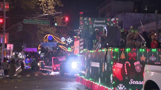 Holiday-themed floats make their way down 125th Street in Harlem. 