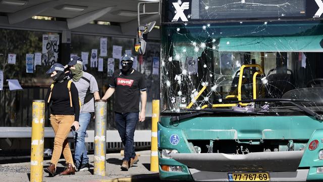 A damaged bus is seen as security forces inspect the area after two separate explosions that took place near the bus stop and at least 14 people were injured in West Jerusalem on November 23, 2022. 