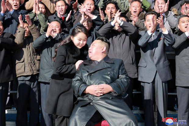 North Korean leader Kim Jong Un and his daughter attend a photo session with personnel involved in the test-fire of the Hwasong-17 intercontinental ballistic missile 
