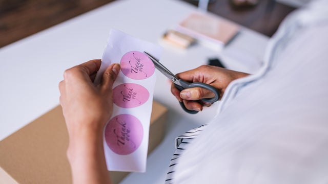An Unrecognizable Businesswoman Preparing A Package For Shipping 
