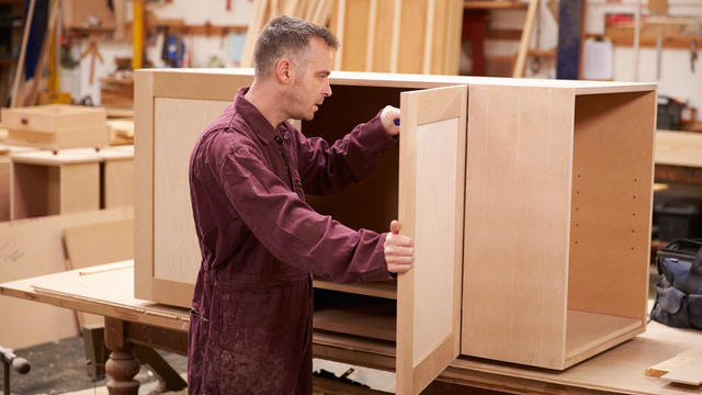 A carpenter building furniture in a workshop 