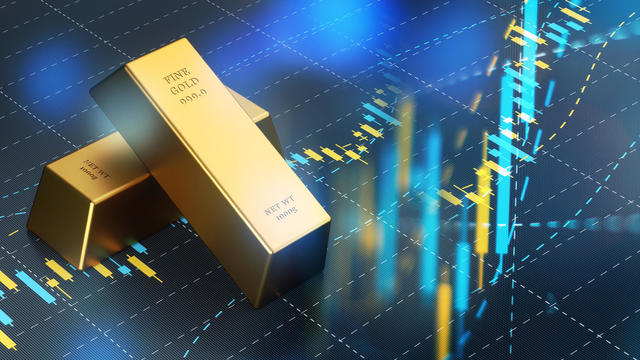 Gold Bars Sitting on Blue Bar Graph, Stock Market and Finance Concept. 