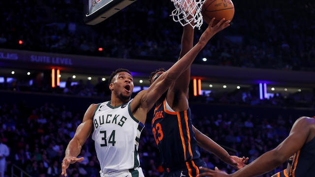 Giannis Antetokounmpo #34 of the Milwaukee Bucks drives to the basket against Mitchell Robinson #23 of the New York Knicks during the second half at Madison Square Garden on November 30, 2022 in New York City. 