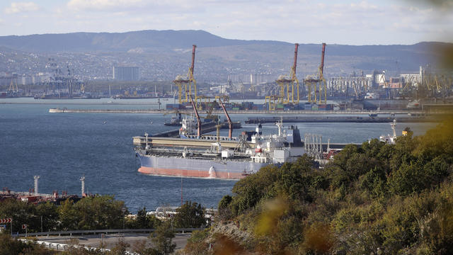 Long shot of oil tanker in port 