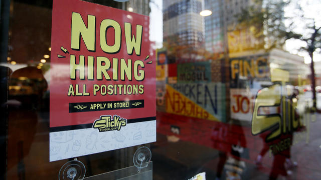 "Now hiring' sign in a store window in NYC 