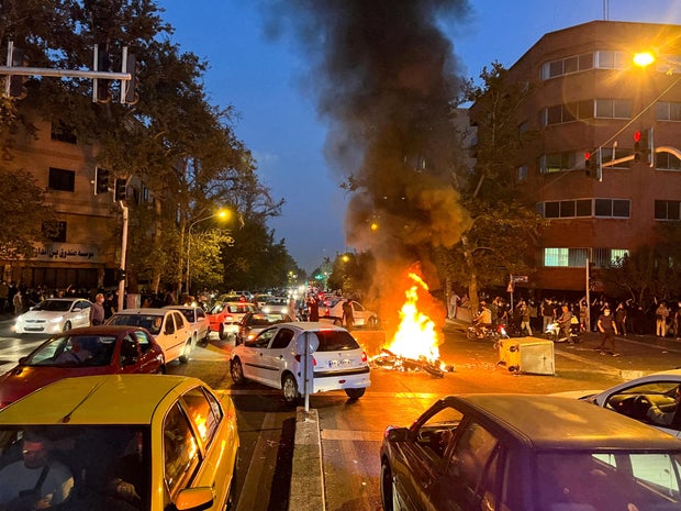 A police motorcycle burns during a protest in Tehran on Sept. 19, 2022