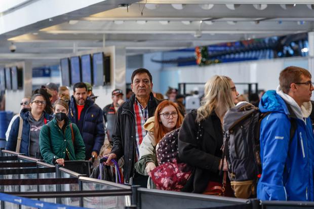 Travelers stand in a security line at O'Hare International Airport in Chicago, Illinois, on November 22, 2022, ahead of Thanksgiving. 