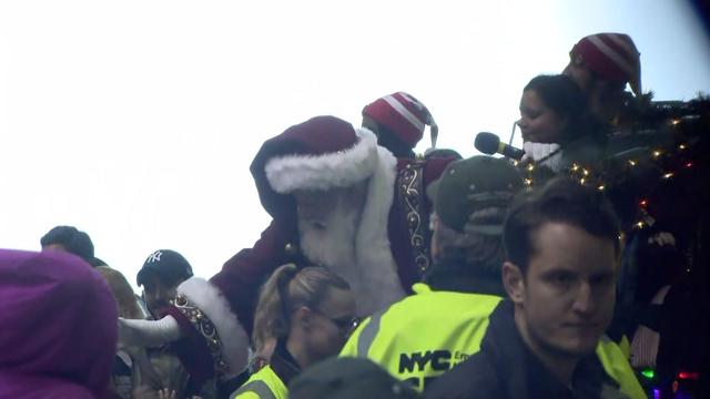 Santa greets children at JFK Airport. 