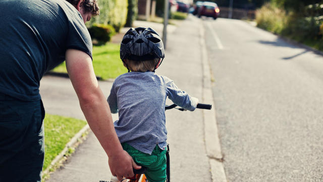 Little boy learning to ride a bicycle 