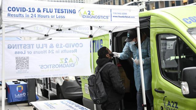 A man gets himself tested for coronavirus (COVID-19) in front of portable cabin as people began wearing mask after New York City's health officials have issued an advisory, strongly urging New Yorkers to use masks as COVID-19, flu, and RSV cases rise, on 