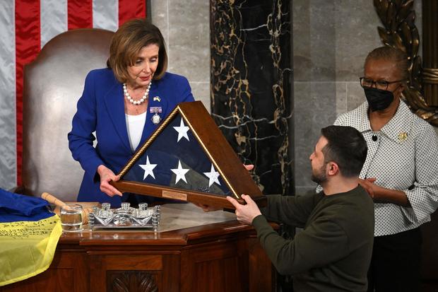 Ukraine's President Volodymyr Zelenskyy receives a U.S. flag from House Speaker Nancy Pelosi 