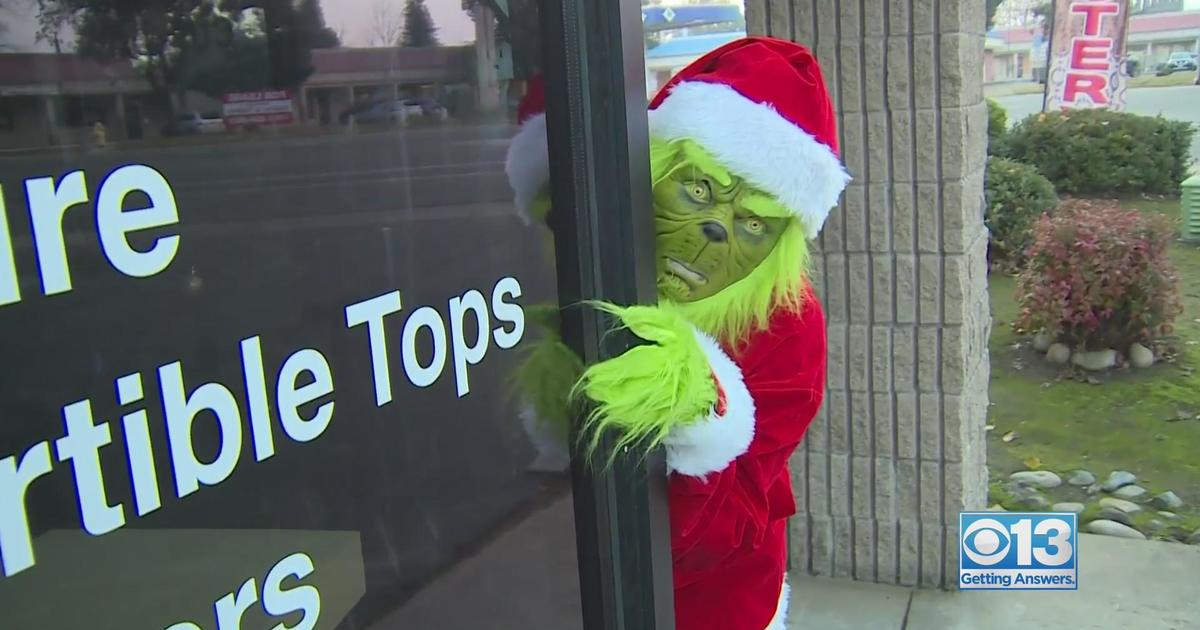 Grinch truck delivers holiday cheer and hope to the QCA 