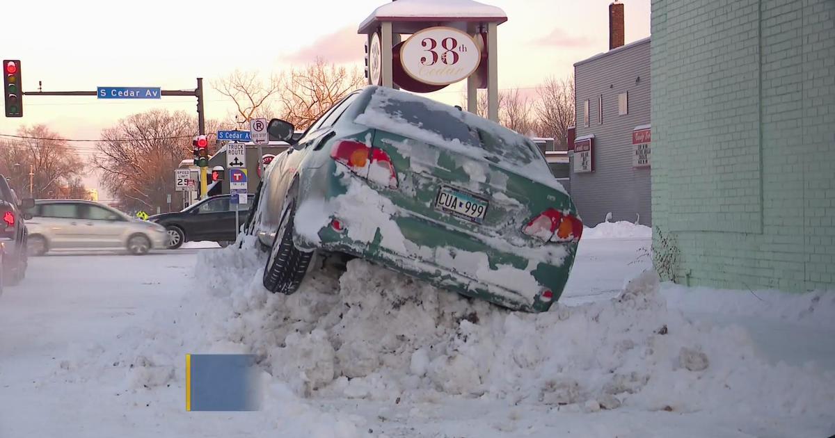Car stuck on giant snowbank in Minneapolis