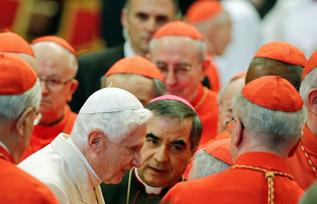 FILE PHOTO: Pope Emeritus Benedict XVI is greeted by Cardinals as he arrives to attend a consistory ceremony in Saint Peter's Basilica at the Vatican