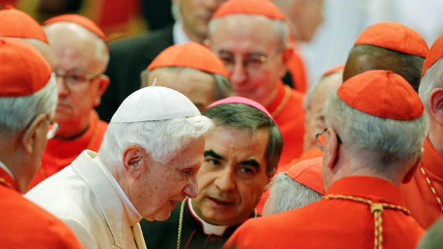 FILE PHOTO: Pope Emeritus Benedict XVI is greeted by Cardinals as he arrives to attend a consistory ceremony in Saint Peter's Basilica at the Vatican 