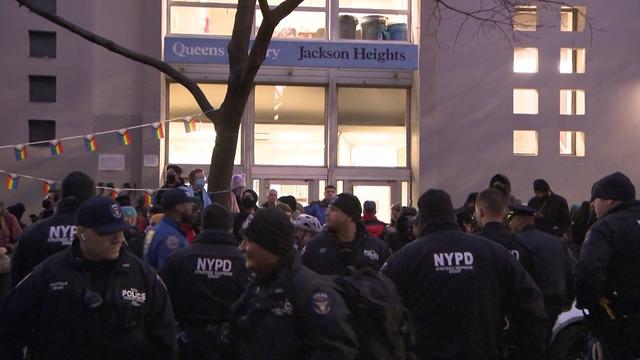 NYPD officers separate opposing crowds of protesters outside the Queens Public Library in Jackson Heights. 