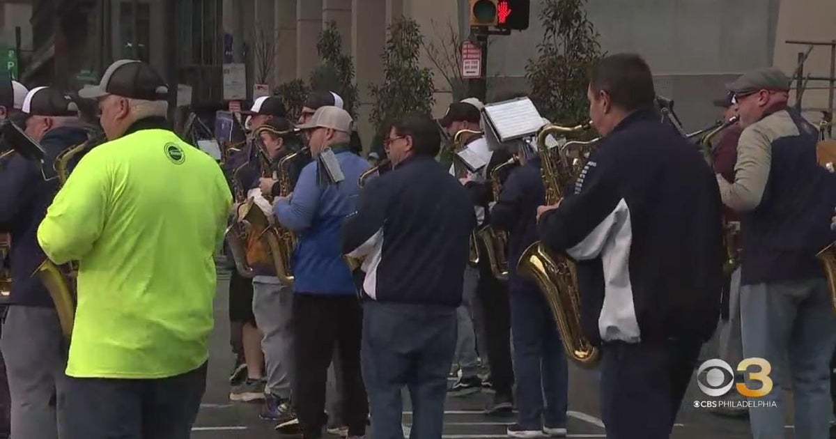 Band members finishing up preparations for Mummers Parade CBS